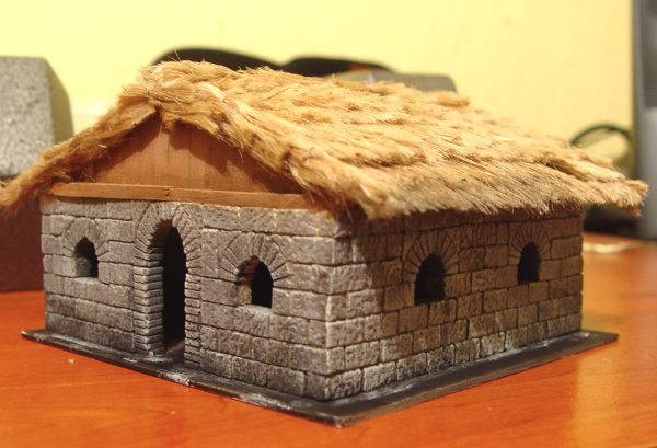 miniature thatched roof cottage
